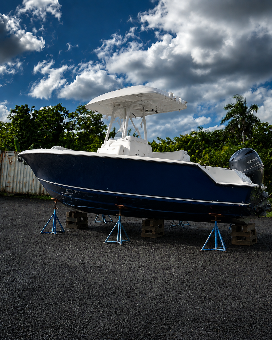 Completed center console boat with a glossy deep navy hull